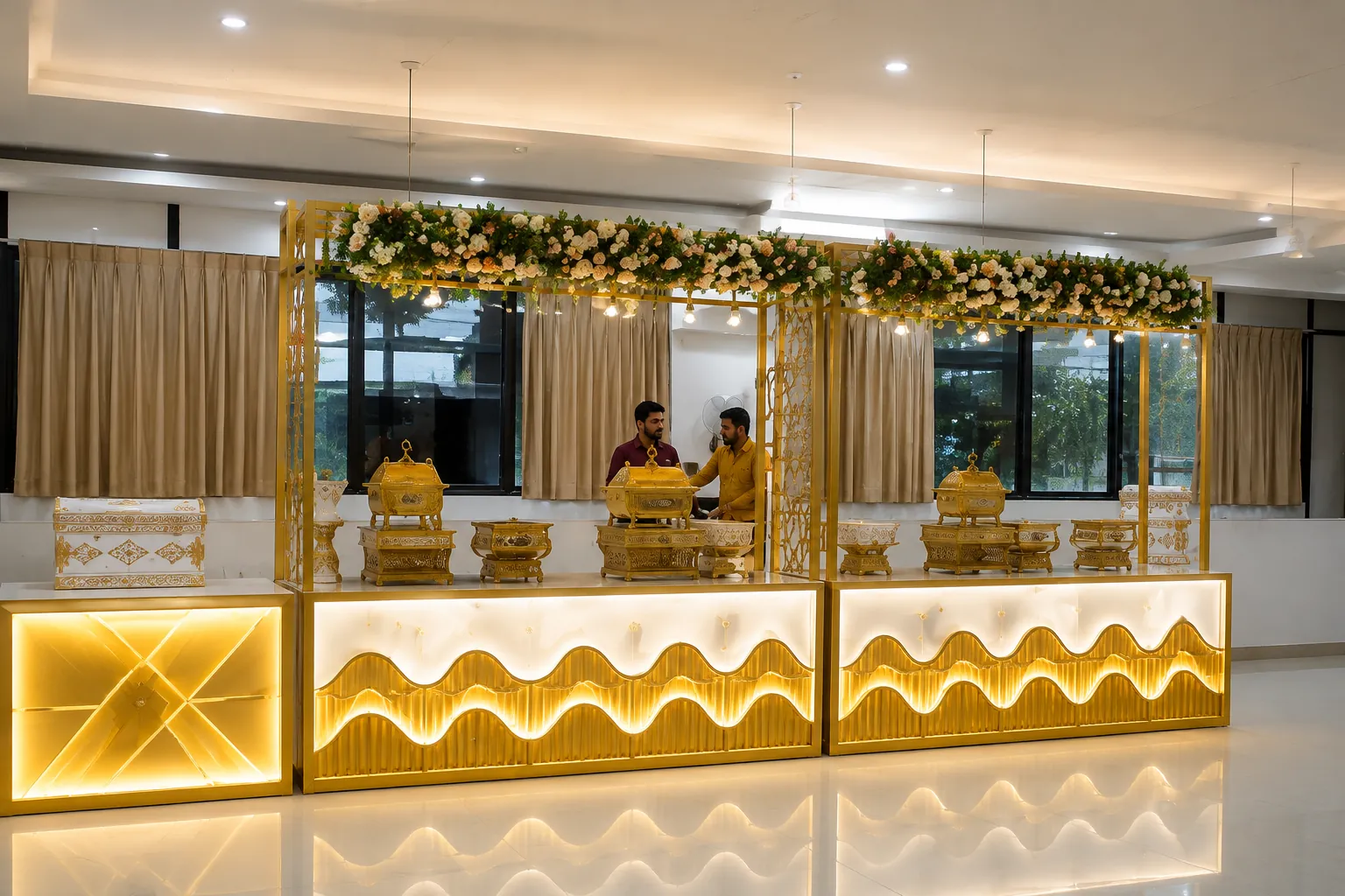 Gold-lit catering counters with a floral canopy at the venue