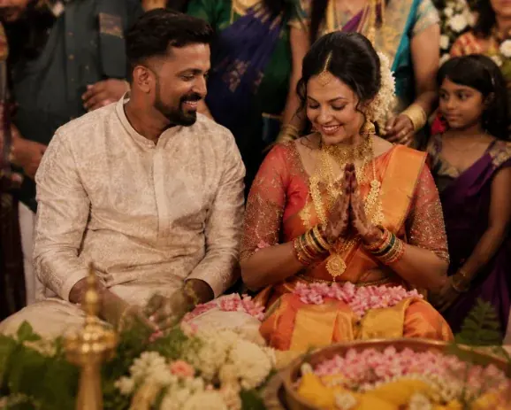 Bride and groom seated during the wedding ceremony surrounded by family