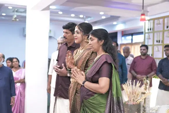 Guests in traditional dress greeting the couple inside the main hall