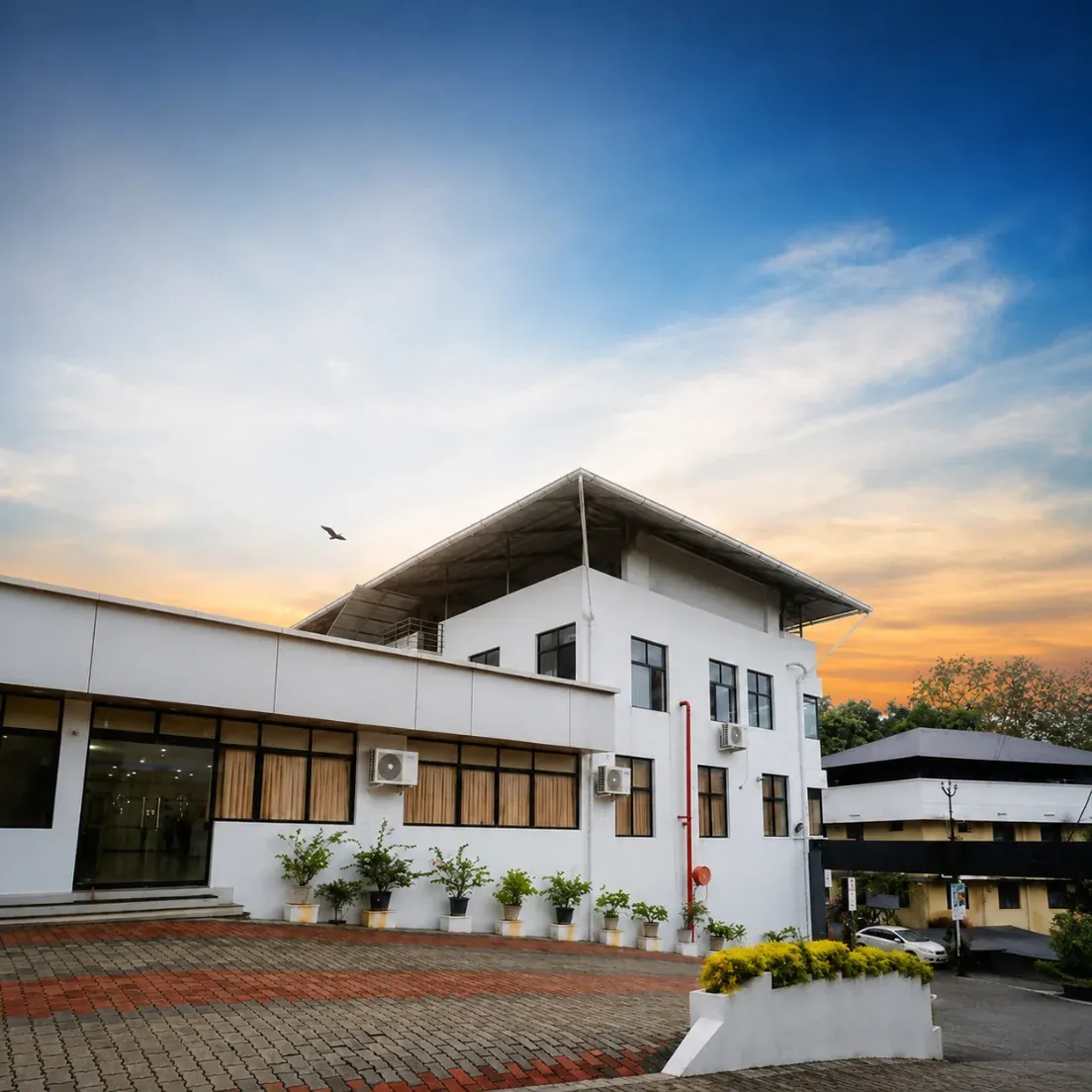 Exterior of S P Convention Center at dusk with the paved forecourt